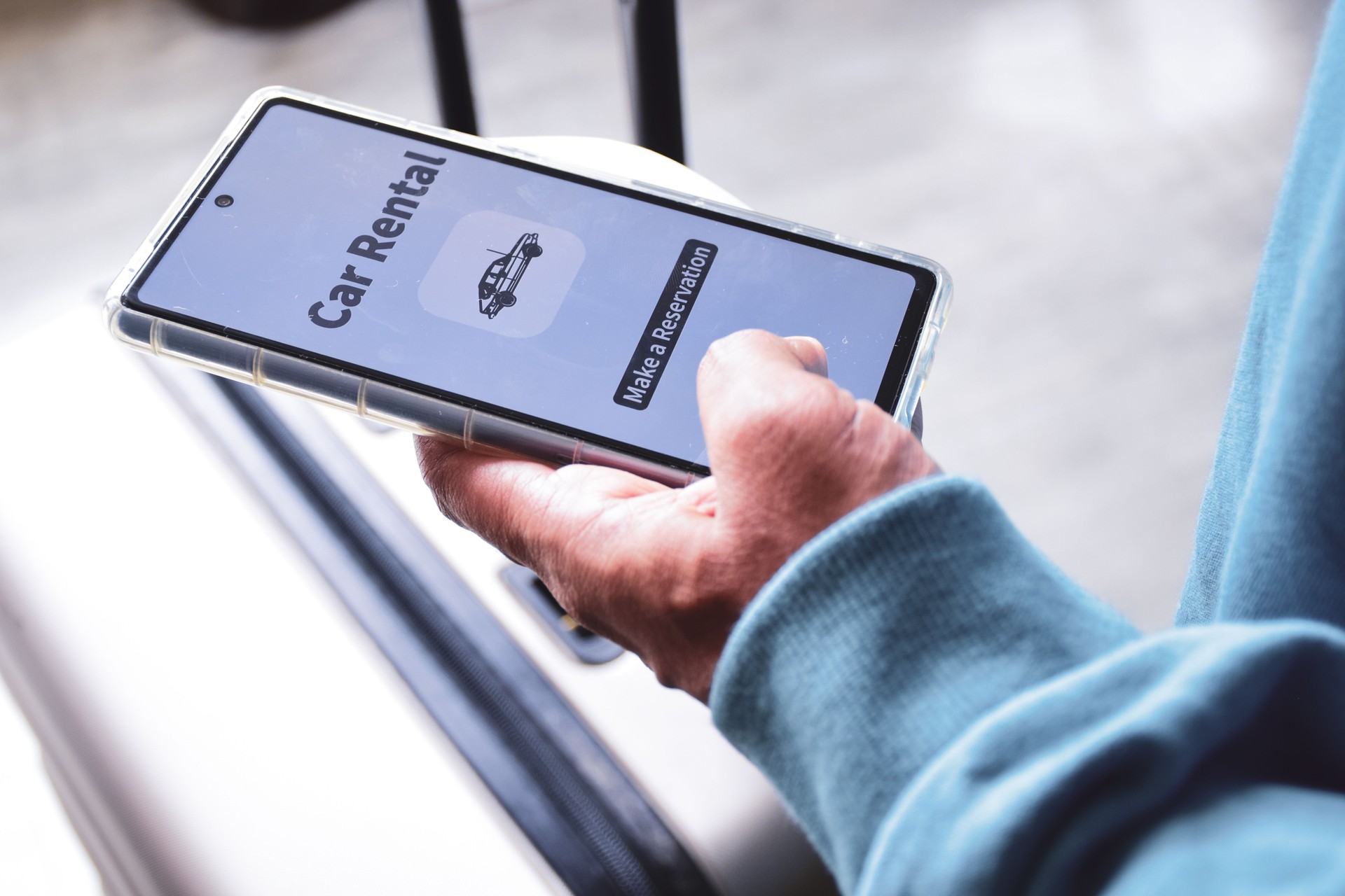 Close up of a person using his phone for car rental upon arrival. Selective focus.