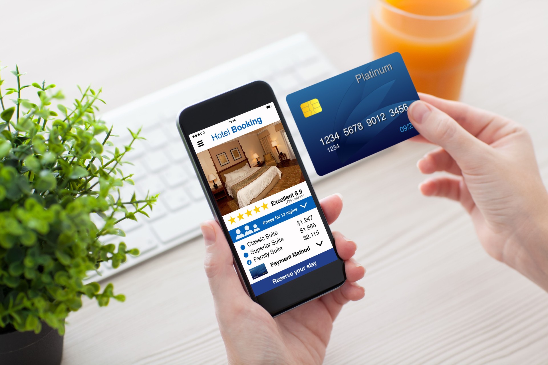 female hands holding phone app hotel booking and credit card