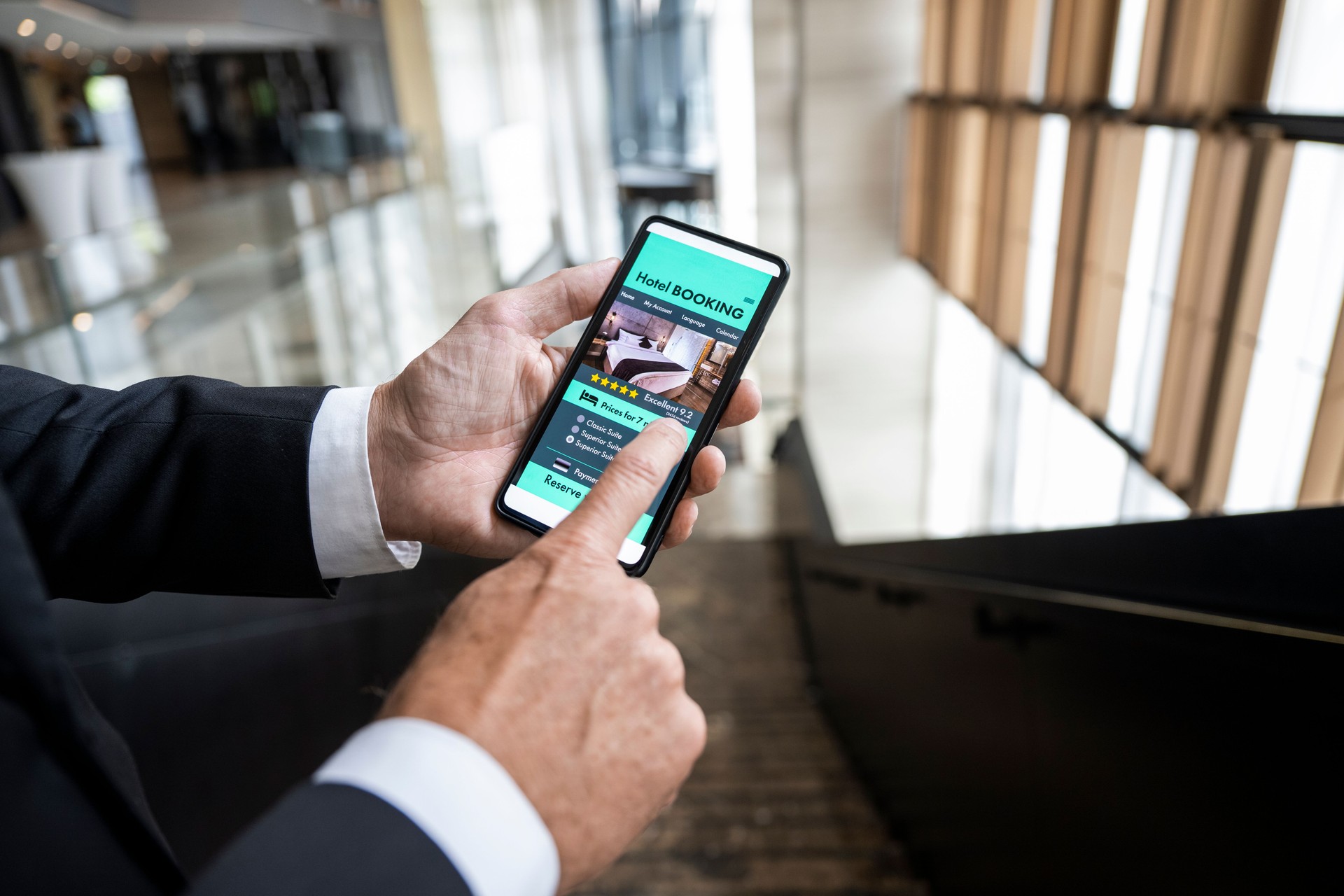 Close up on a mobile phone with an online booking app on the screen